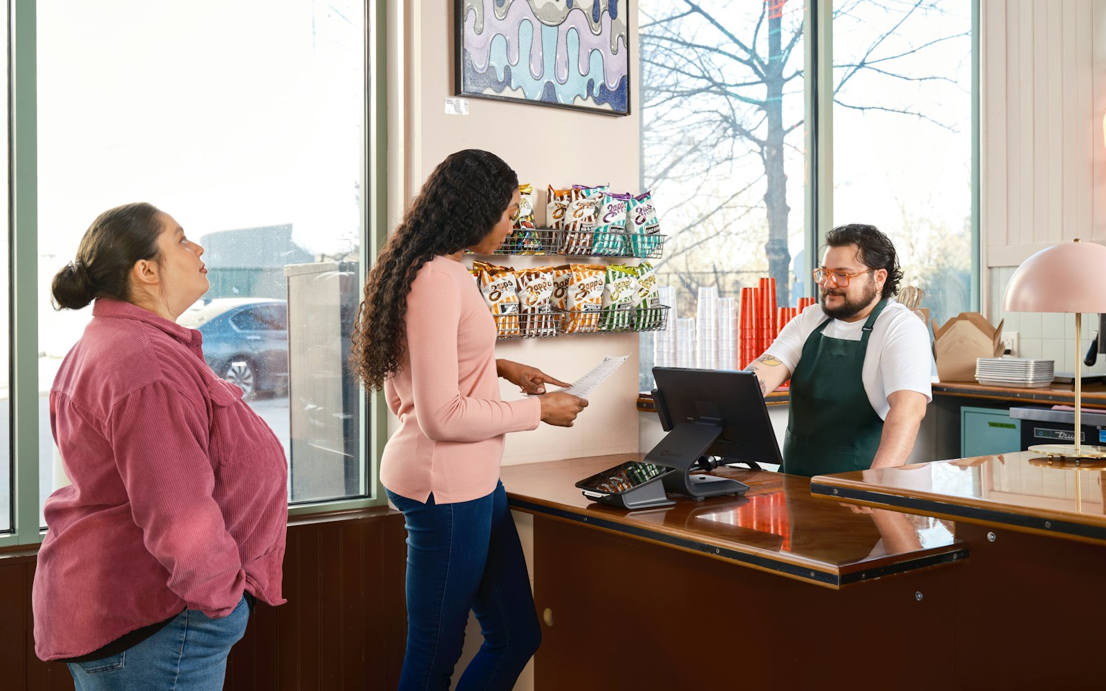 Customer speaking with a service employee at a retail counter